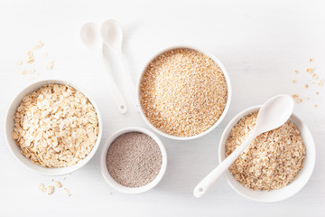 variaty of raw cereals for breakfast. Oatmeal flakes and steel cut, barley, chia. Healthy ingredients
