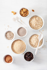variaty of raw cereals and nuts for breakfast. Oatmeal flakes and steel cut, barley, walnut, chia, raisins. Healthy ingredients