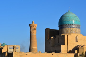 A view of the roofs of the ancient buildings, the sights of the mmeheti, the minaret of Kalyan in the city of Bukhara. Uzbekistan. Copy space for your text