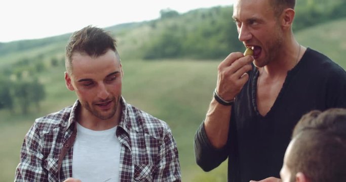 Group of friends spending time making a picnic and a barbeque. shot in slow motion