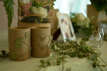 HO CHI MINH CITY, VIET NAM, MARCH, 2018: Original wedding floral decoration in the form of mini-vases and bouquets of flowers put in the table with beautiful mat, green style wedding, a modern wedding