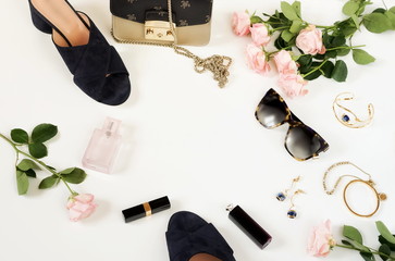 Summer female fashion stylish lyxury clothes composition. Sandals, bag, sunglasses, make up products, accesories, pale pink roses on white background. Flat lay, top view collage.copy space - obrazy, fototapety, plakaty