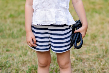 little girl holding a dog leash