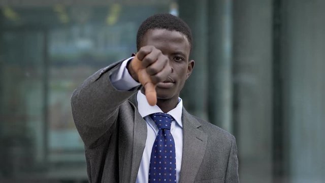 American african business man makinh thumb down.- negativity, failure