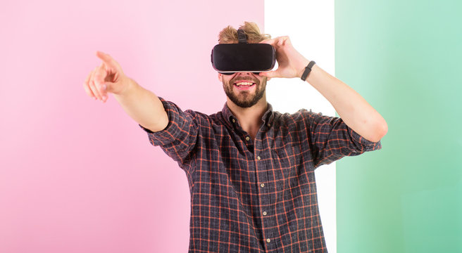 Cyber space. Man unshaven guy with VR glasses involved in cyber space, pink background. Hipster use modern technologies for entertainment. Guy VR glasses head mounted display interact in cyber space