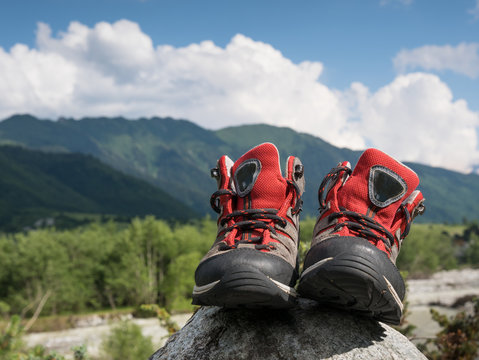 hiking boots and mountains landscape