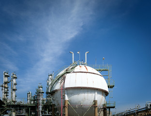 Close up of Gas storage sphere tanks and smoke stack in petrochemical plant