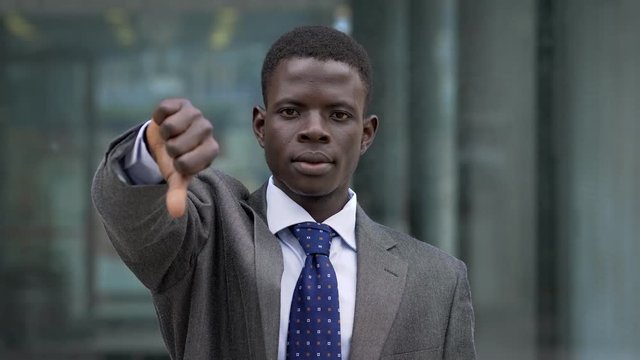 Young black african manager making thumb down- outdoor