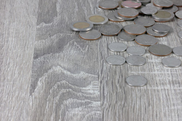 Coins are on the wooden gray table