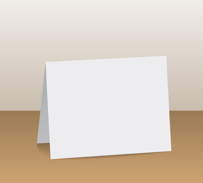 Realistic White Blank Folded Paper Card Standing On Wooden Table Top