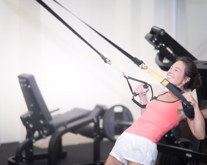 Middle aged woman in gym, health lifestyle, mature fit woman take exercises. Fitness woman workout in the gym. Fitness woman workout