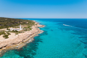 Fototapeta na wymiar Aerial: Cape Ses Salines lighthouse in Mallorca