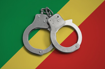 Congo flag  and police handcuffs. The concept of observance of the law in the country and...