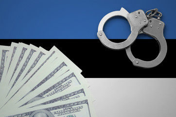 Estonia flag  with handcuffs and a bundle of dollars. The concept of illegal banking operations in...