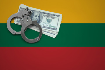 Lithuania flag  with handcuffs and a bundle of dollars. The concept of breaking the law and thieves...
