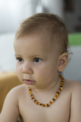 baby toddler wearing amber teeth pain relief neckless