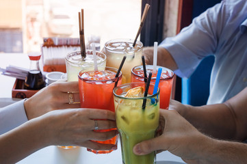 a company of people without faces holds cocktails and checks