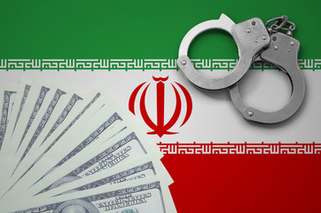 Iran flag  with handcuffs and a bundle of dollars. The concept of illegal banking operations in US...