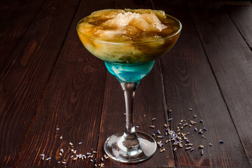 One alcoholic cocktail in a transparent glass