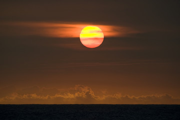 The sun sets over the ocean