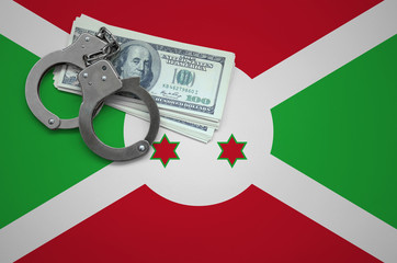 Burundi flag  with handcuffs and a bundle of dollars. The concept of breaking the law and thieves...