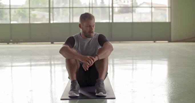 Young adult man resting in recovering pause portrait during fitness sport workout .Grunge industrial urban training.4k slow motion video