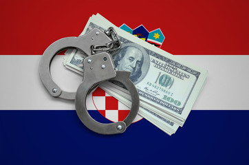 Croatia flag  with handcuffs and a bundle of dollars. Currency corruption in the country. Financial...