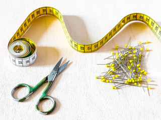 Sewing centimeter, scissors and pins for winding
