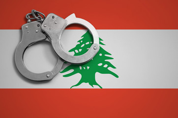Lebanon flag  and police handcuffs. The concept of crime and offenses in the country