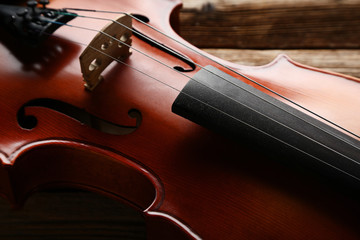Fototapeta na wymiar Violin on brown wooden table