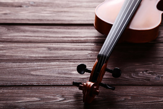 Violin on brown wooden table