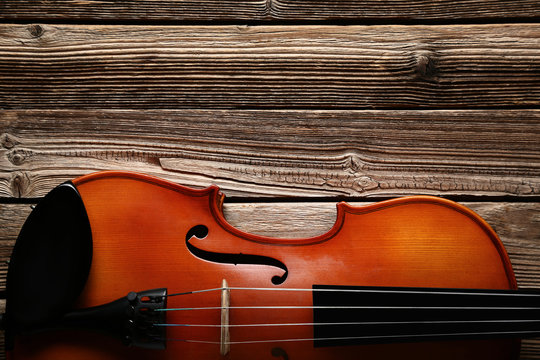 Violin on brown wooden table