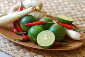 Set of asian spices: kaffir limes, lemongrass, bird's eye chilis, ginger. Suitable for tom yum and hot pot making.