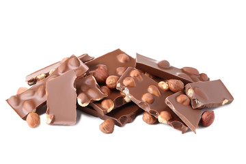 Chocolate pieces with hazelnuts isolated on white background