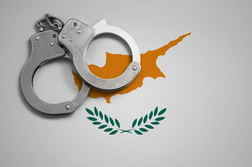 Cyprus flag  and police handcuffs. The concept of crime and offenses in the country