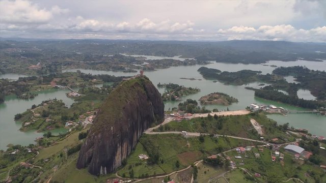 Flying over Piedra Del Penol in Guatape, one of Colombia's most unique natural landmarks. A giant stone rock surrounded by beautiful lakes.