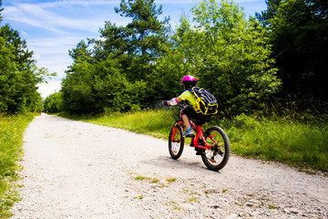 Little girl going in bicycle