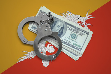 Bhutan flag  with handcuffs and a bundle of dollars. Currency corruption in the country. Financial...