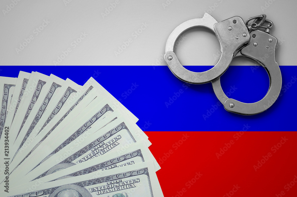 Wall mural Russia flag  with handcuffs and a bundle of dollars. The concept of illegal banking operations in US currency