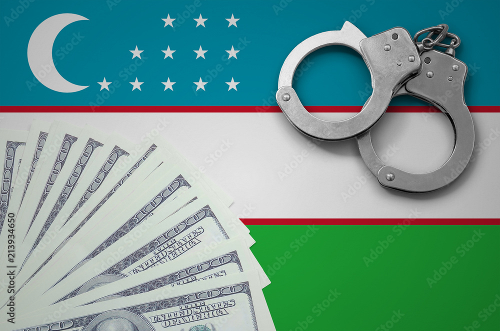 Wall mural Uzbekistan flag  with handcuffs and a bundle of dollars. The concept of illegal banking operations in US currency