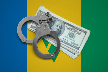 Saint Vincent and the Grenadines flag  with handcuffs and a bundle of dollars. Currency corruption...