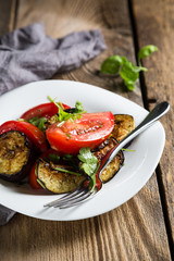 Salad of baked eggplants and fresh tomatoes with parsley