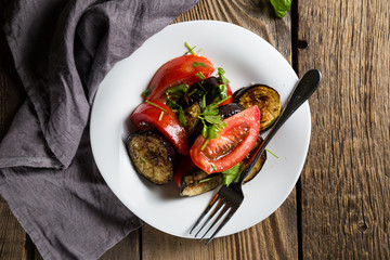 Salad of baked eggplants and fresh tomatoes with parsley