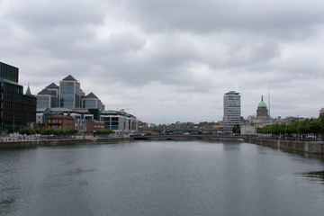 Fototapeta na wymiar River Liffey, Georges Quay Plaza, Liberty Hall and Custom House in Dublin, Ireland