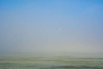 Scenic sea beach on blue sky and white sand