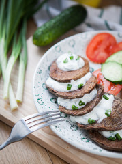 Small pancakes made with liver and sour cream and vegetables