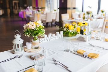 Table decoration with fresh flowers and white lantern