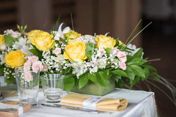 Table decoration with fresh flowers and white lantern
