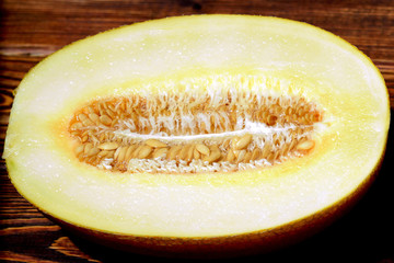 Melon cut in half with uncooked seeds