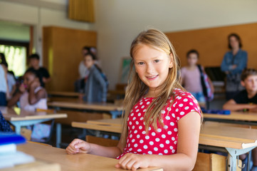 Indoor portrait of a cute little girl in a classroom